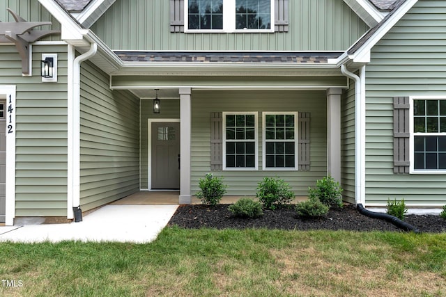 1412 Sagamore Dr, Louisburg, NC 27549 - doorway to property featuring board and batten siding, a porch, and a yard
