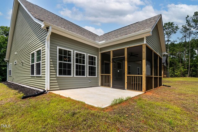1412 Sagamore Dr, Louisburg, NC 27549 - back of property with a sunroom, a lawn, a patio area, a shingled roof, and ceiling fan
