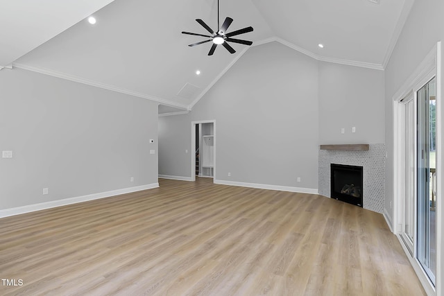 1412 Sagamore Dr, Louisburg, NC 27549 - unfurnished living room with crown molding, ceiling fan, light wood finished floors, a fireplace, and high vaulted ceiling