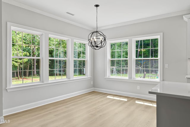 1412 Sagamore Dr, Louisburg, NC 27549 - unfurnished dining area with light wood finished floors, plenty of natural light, ornamental molding, and a chandelier