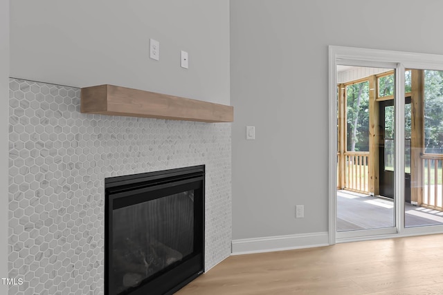 1412 Sagamore Dr, Louisburg, NC 27549 - unfurnished living room featuring wood finished floors and a glass covered fireplace
