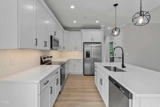 1412 Sagamore Dr, Louisburg, NC 27549 - kitchen featuring stainless steel appliances, a center island with sink, white cabinets, recessed lighting, and hanging light fixtures