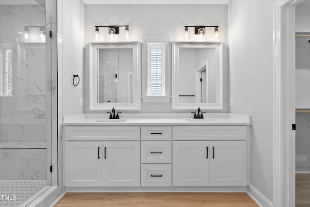 1412 Sagamore Dr, Louisburg, NC 27549 - full bath with a marble finish shower, double vanity, and wood finished floors