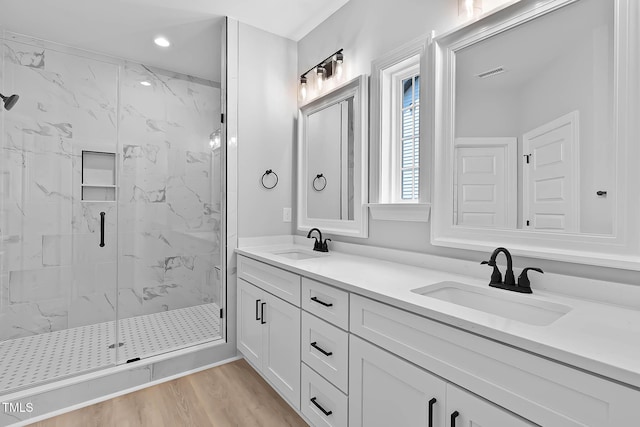 1412 Sagamore Dr, Louisburg, NC 27549 - full bath with a marble finish shower, double vanity, wood finished floors, and recessed lighting