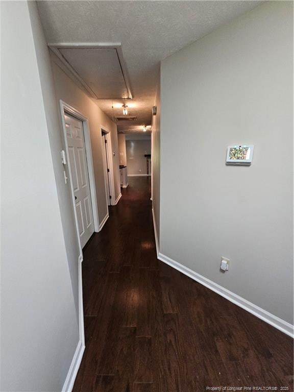 5472 Robmont Dr, Fayetteville, NC 28306 - hall with attic access, baseboards, and wood finished floors