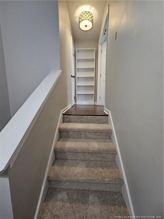 5472 Robmont Dr, Fayetteville, NC 28306 - stairway with baseboards and carpet floors