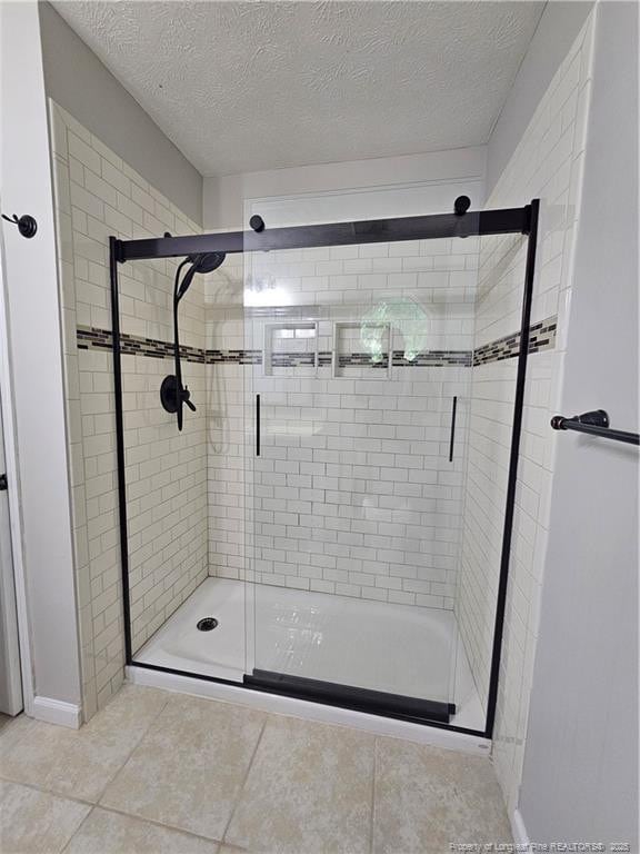 5472 Robmont Dr, Fayetteville, NC 28306 - full bath featuring a textured ceiling, tile patterned flooring, and a stall shower