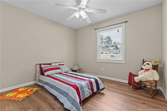 6750 Weeping Water Run, Fayetteville, NC 28314 - bedroom featuring wood finished floors, baseboards, and ceiling fan