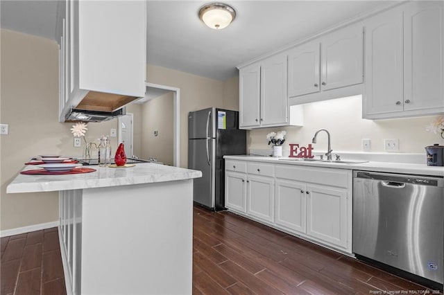 6750 Weeping Water Run, Fayetteville, NC 28314 - kitchen with a sink, dark wood-style flooring, stainless steel appliances, and white cabinets