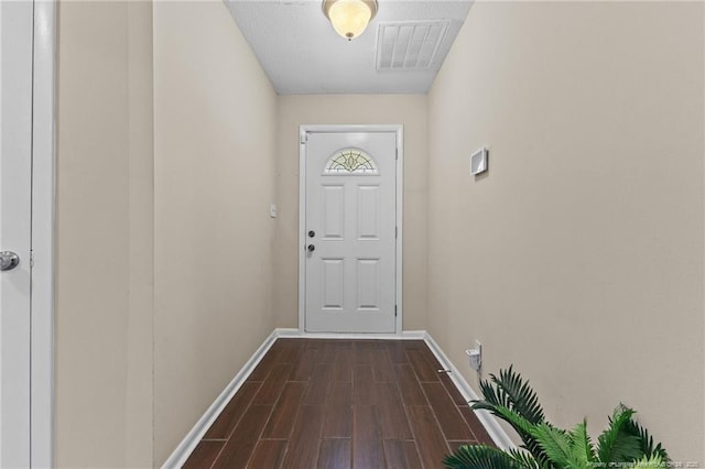 6750 Weeping Water Run, Fayetteville, NC 28314 - entryway with visible vents, baseboards, and dark wood-type flooring