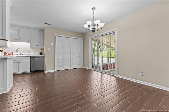 6750 Weeping Water Run, Fayetteville, NC 28314 - unfurnished dining area with baseboards, an inviting chandelier, a sink, and wood tiled floor