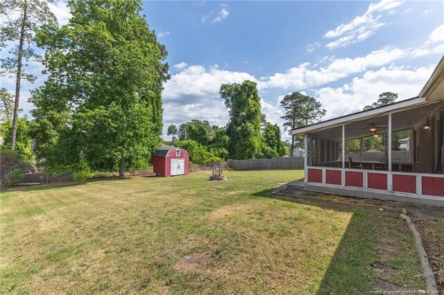 6750 Weeping Water Run, Fayetteville, NC 28314 - view of yard with a sunroom, a storage shed, an outbuilding, and fence