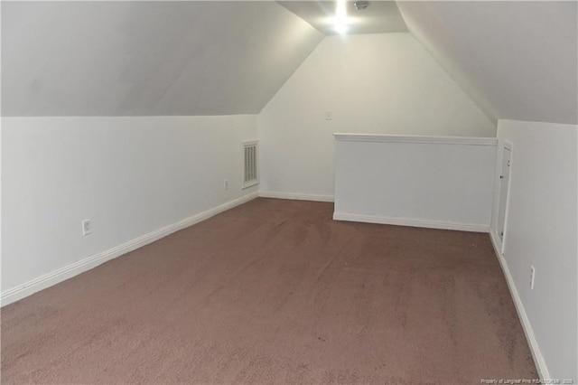 additional living space featuring carpet floors, lofted ceiling, and baseboards