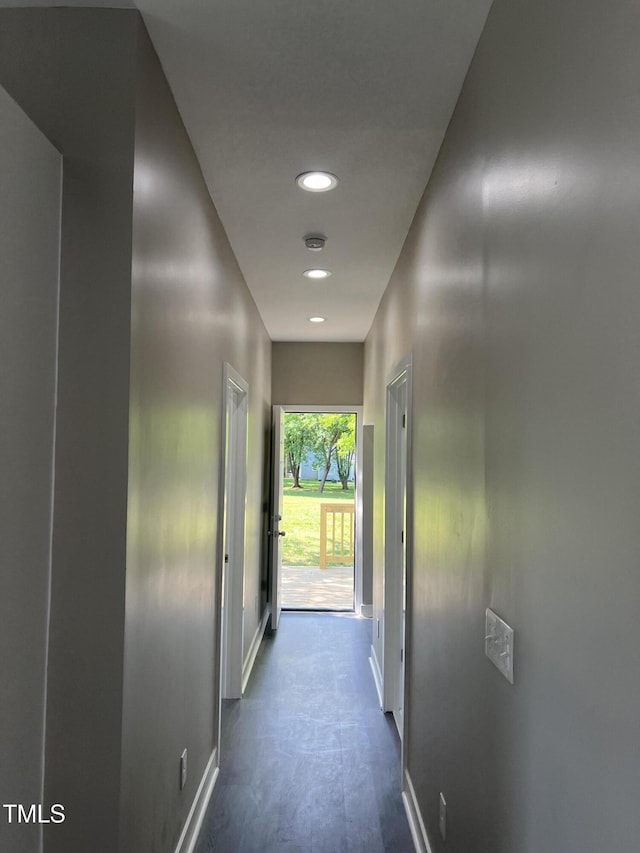 corridor featuring baseboards and recessed lighting