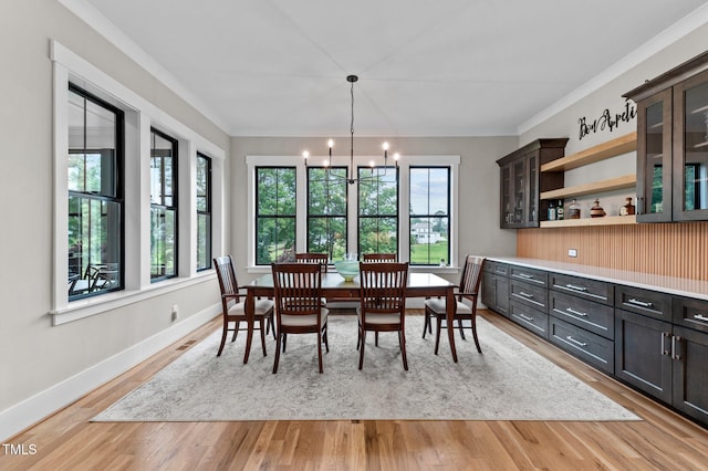 1229 Perry Bluff Dr, Wake Forest, NC 27587 - dining space featuring a chandelier, light wood-style flooring, ornamental molding, and baseboards