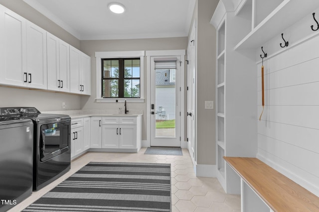 1229 Perry Bluff Dr, Wake Forest, NC 27587 - clothes washing area featuring washer and clothes dryer, cabinet space, light tile patterned floors, and ornamental molding