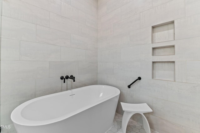 1229 Perry Bluff Dr, Wake Forest, NC 27587 - bathroom with tile walls and a freestanding bath
