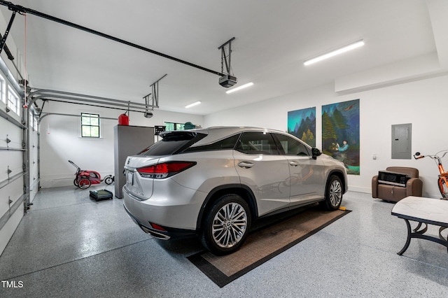 1229 Perry Bluff Dr, Wake Forest, NC 27587 - garage featuring a garage door opener, baseboards, and electric panel