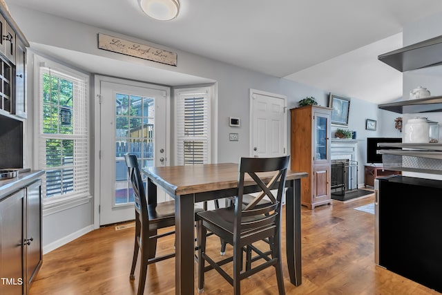 dining space featuring light wood-style floors and baseboards