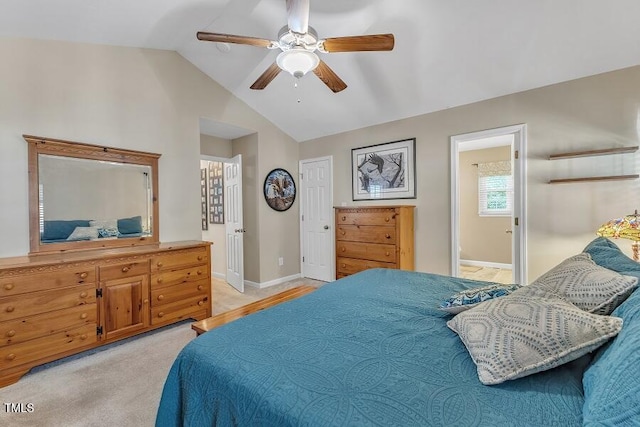 bedroom with vaulted ceiling, baseboards, a ceiling fan, and ensuite bathroom