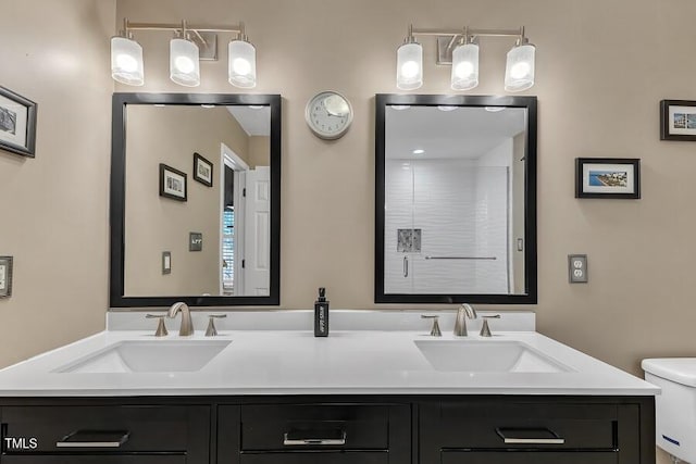 full bath featuring toilet and double vanity