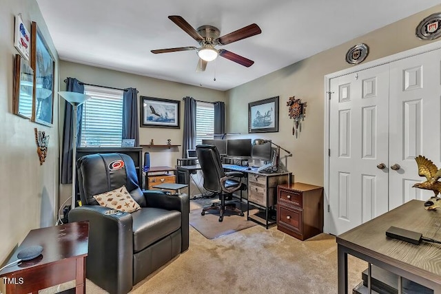 home office featuring a ceiling fan and light colored carpet