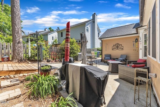 view of patio featuring fence, an outdoor living space with a fire pit, and area for grilling