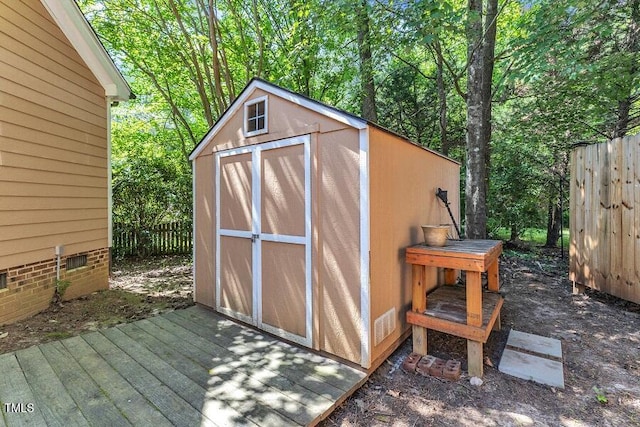 view of shed featuring fence