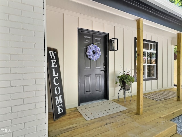 116 Lumpkin St, Raleigh, NC 27610 - doorway to property featuring board and batten siding and covered porch