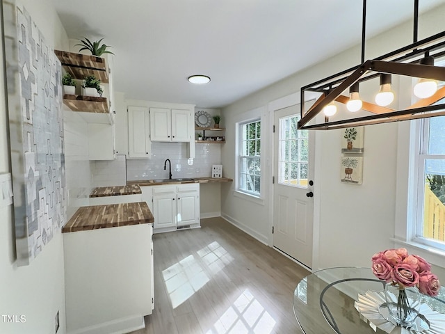 116 Lumpkin St, Raleigh, NC 27610 - kitchen featuring wood counters, open shelves, a sink, and white cabinetry