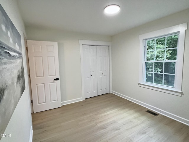 116 Lumpkin St, Raleigh, NC 27610 - unfurnished bedroom featuring wood finished floors, a closet, and baseboards