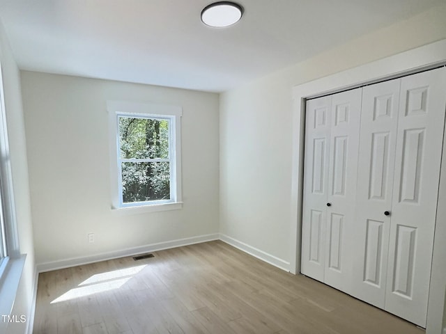 116 Lumpkin St, Raleigh, NC 27610 - unfurnished bedroom featuring wood finished floors, a closet, and baseboards