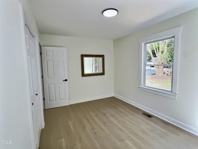 116 Lumpkin St, Raleigh, NC 27610 - unfurnished bedroom with wood finished floors, baseboards, and a closet