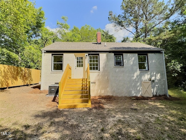 116 Lumpkin St, Raleigh, NC 27610 - back of property with a chimney, brick siding, fence, and cooling unit