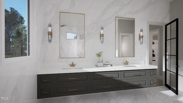 full bath featuring double vanity, marble finish floors, and healthy amount of natural light