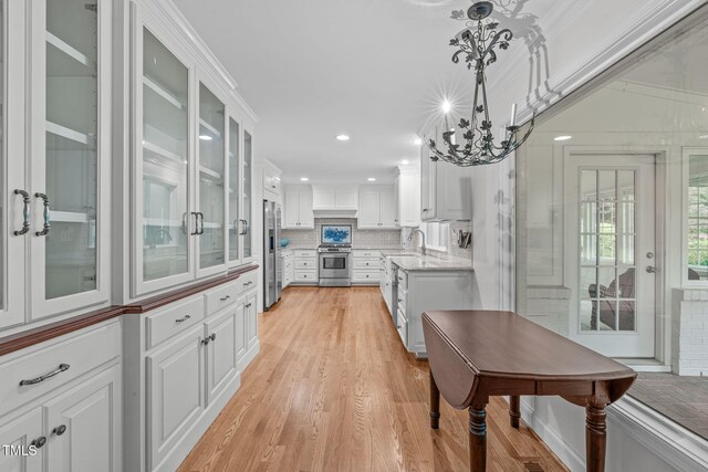 4830 N Hls, Raleigh, NC 27612 - kitchen with stainless steel appliances, decorative backsplash, white cabinetry, light wood finished floors, and recessed lighting