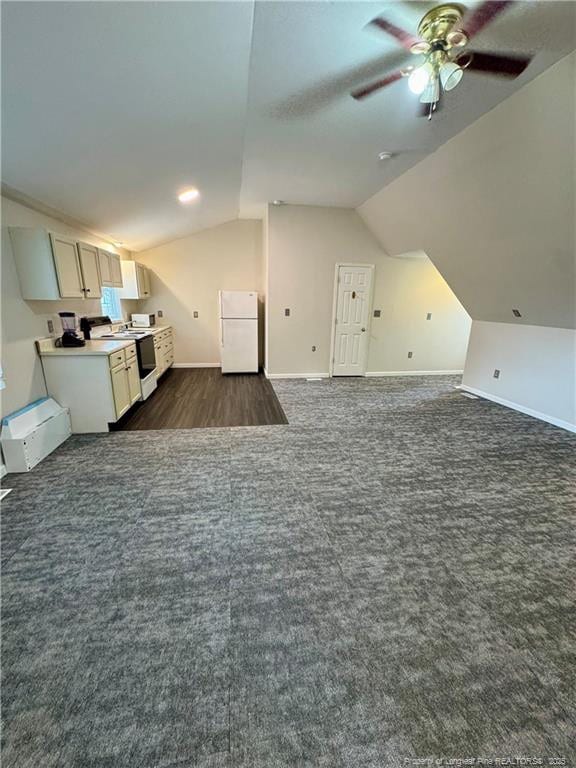 bonus room featuring baseboards, dark colored carpet, ceiling fan, and vaulted ceiling