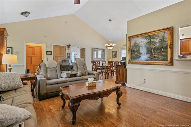 5201 Flynn Dr, Lumberton, NC 28360 - living room featuring a chandelier, wood finished floors, high vaulted ceiling, and baseboards