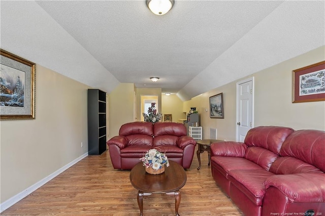 5201 Flynn Dr, Lumberton, NC 28360 - living room with light wood-type flooring, lofted ceiling, baseboards, and a textured ceiling