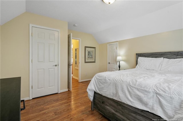 5201 Flynn Dr, Lumberton, NC 28360 - bedroom with vaulted ceiling, baseboards, and wood finished floors