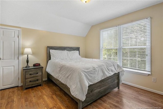5201 Flynn Dr, Lumberton, NC 28360 - bedroom featuring lofted ceiling, wood finished floors, and baseboards