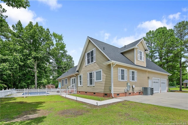 5201 Flynn Dr, Lumberton, NC 28360 - view of home's exterior featuring crawl space, central air condition unit, driveway, roof with shingles, and a garage