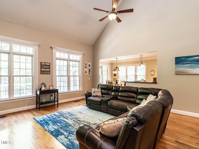 91 E Walker Woods Ln, Clayton, NC 27527 - living room featuring a ceiling fan, baseboards, wood finished floors, and high vaulted ceiling