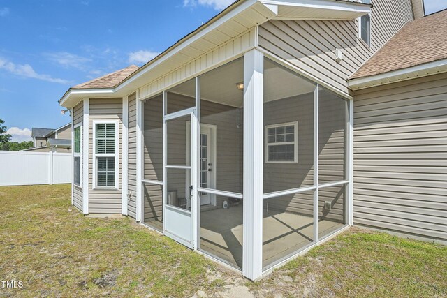 265 Wind Swept St, Raeford, NC 28376 - view of property exterior with a sunroom and roof with shingles