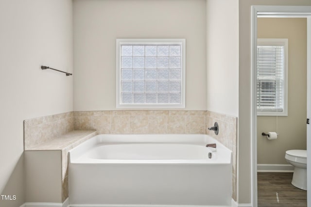 265 Wind Swept St, Raeford, NC 28376 - bathroom with a bath, toilet, baseboards, and wood finished floors