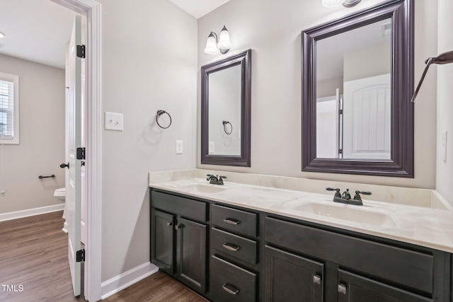 265 Wind Swept St, Raeford, NC 28376 - bathroom featuring double vanity, wood finished floors, and baseboards