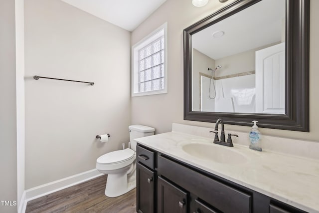 265 Wind Swept St, Raeford, NC 28376 - full bathroom with wood finished floors, toilet, vanity, baseboards, and a shower