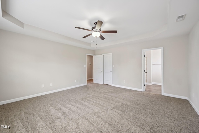 265 Wind Swept St, Raeford, NC 28376 - unfurnished bedroom with a raised ceiling, baseboards, and carpet flooring