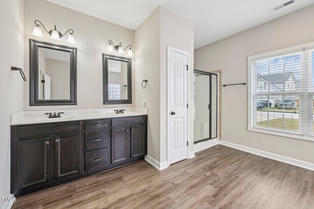 265 Wind Swept St, Raeford, NC 28376 - full bathroom featuring wood finished floors, a shower stall, baseboards, and double vanity