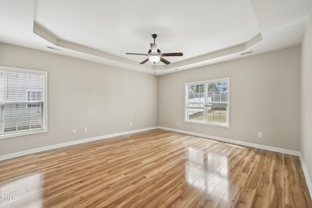 265 Wind Swept St, Raeford, NC 28376 - empty room with a raised ceiling, light wood finished floors, ceiling fan, and baseboards